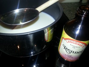 Adding rennet to warm milk to make curd cheese